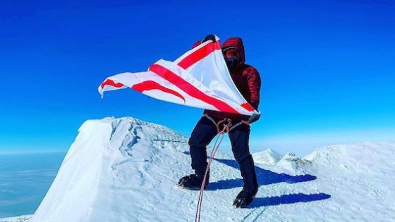 Turkish Cypriot mountaineer waves the flag of TRNC on the summit of Mount Vinson, the highest point in Antarctica